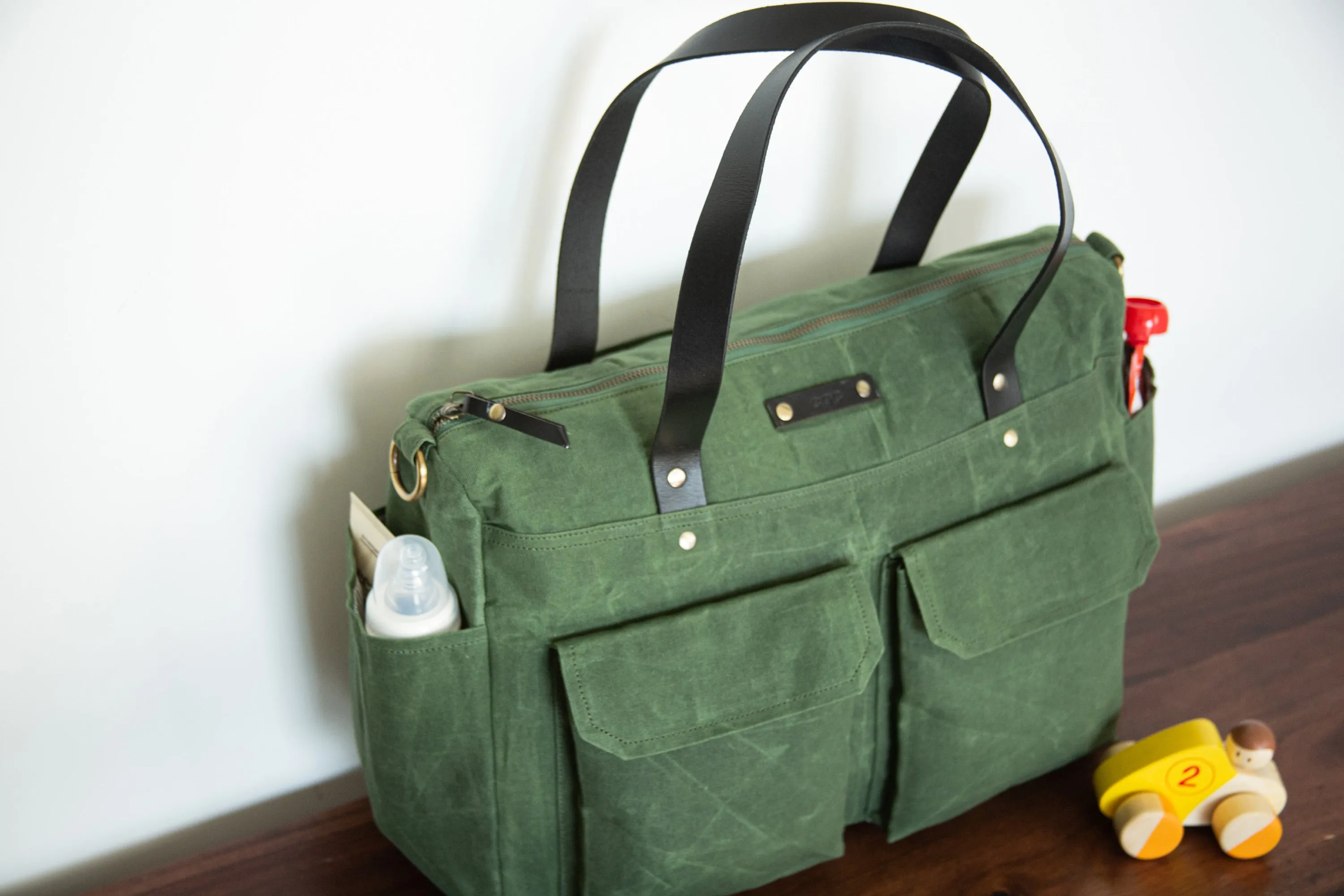 Pipa 11 Pocket Crossbody Diaper Bag Tote in Forest Green | Waxed Canvas & Leather